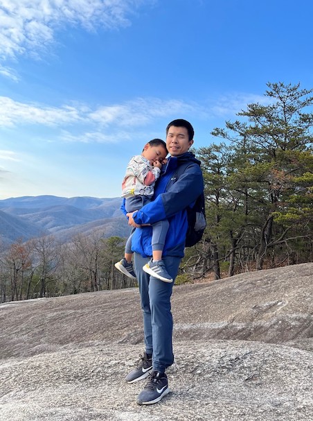 Liu and his son pose after a tiring day of hiking and adventure.