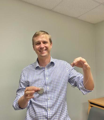 man showing DBS device