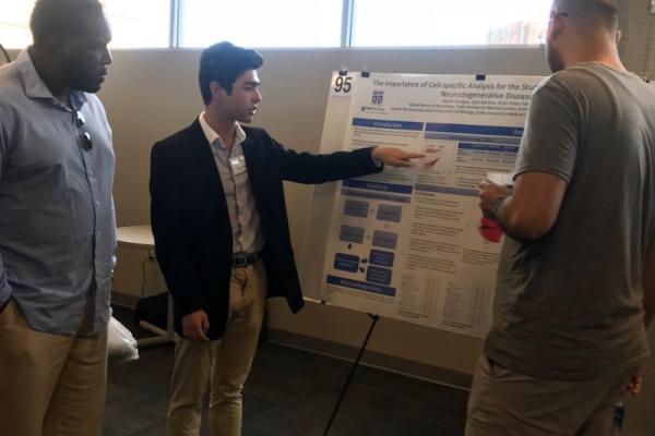 Daniel Sprague presenting a poster