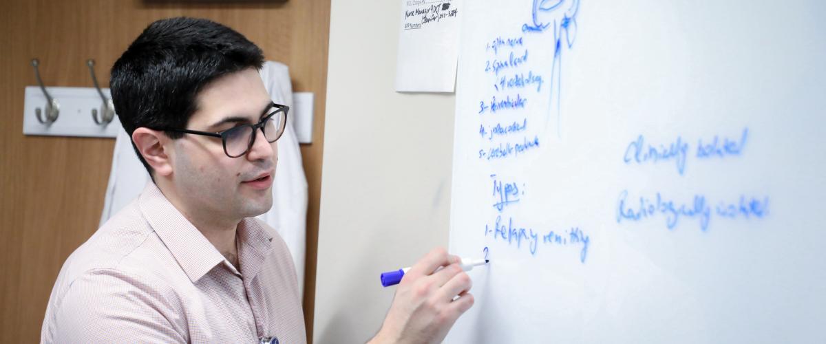 Resident writing on whiteboard